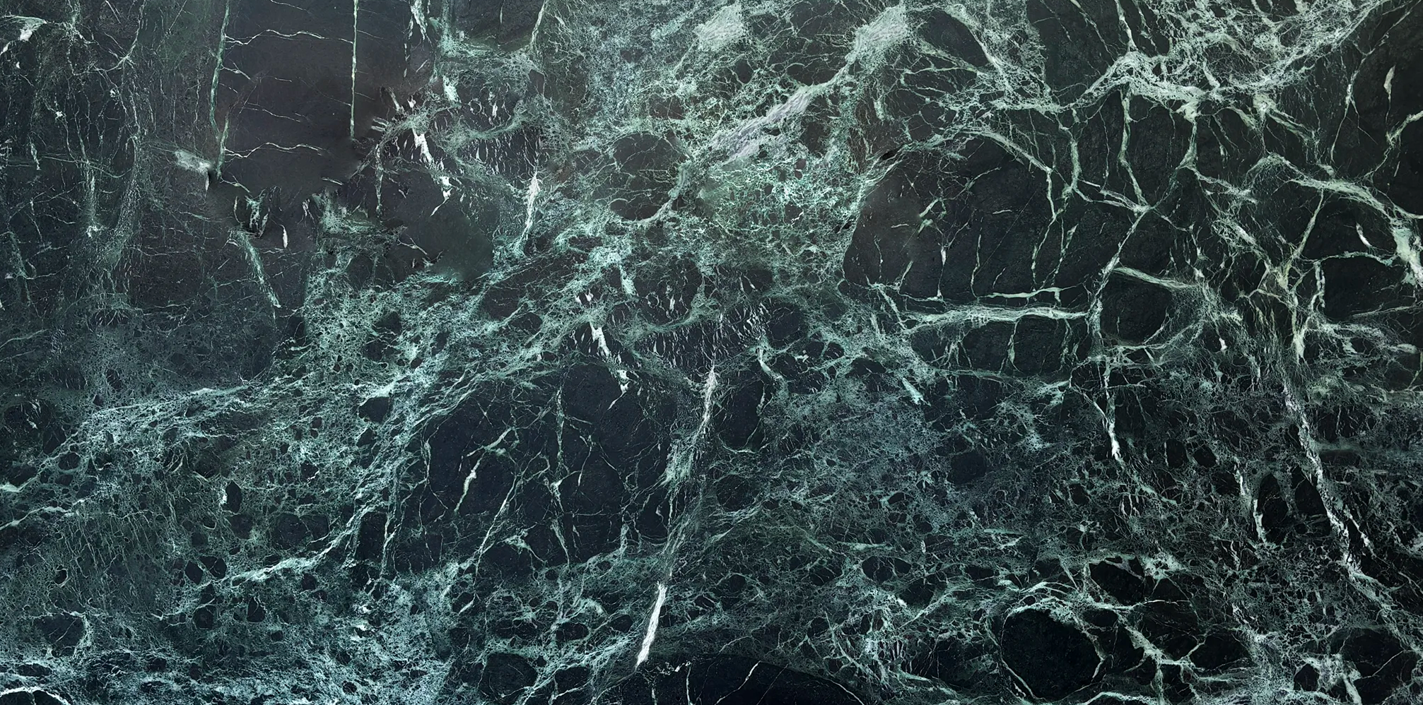 Dark green and black marble surface with intricate white veining running across it, creating an organic web like pattern. The polished stone texture adds a sleek and luxurious backdrop suitable for branding cosmetic medicine treatments across Sydney.